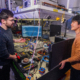 Image showing two students, one male and one female, chatting against a lab background