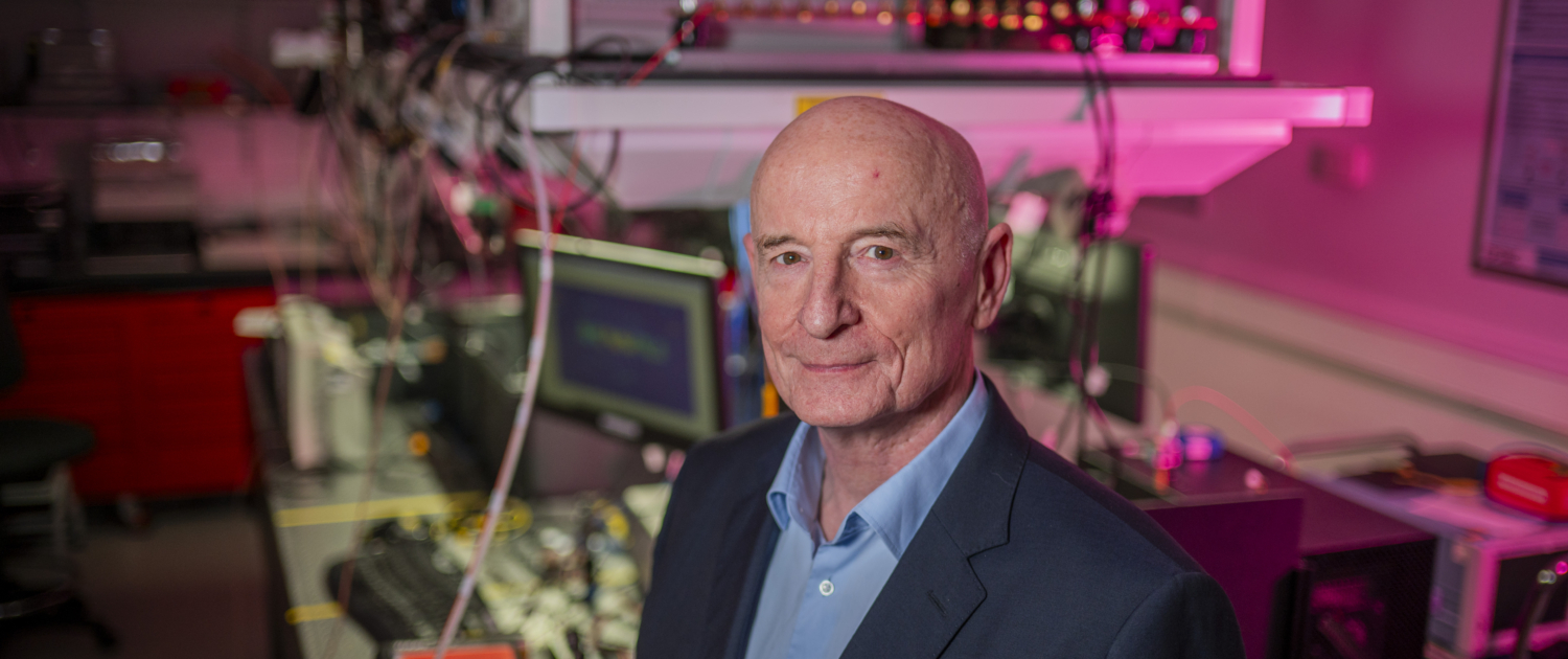 Image of a white, middle aged bald man in a science lab